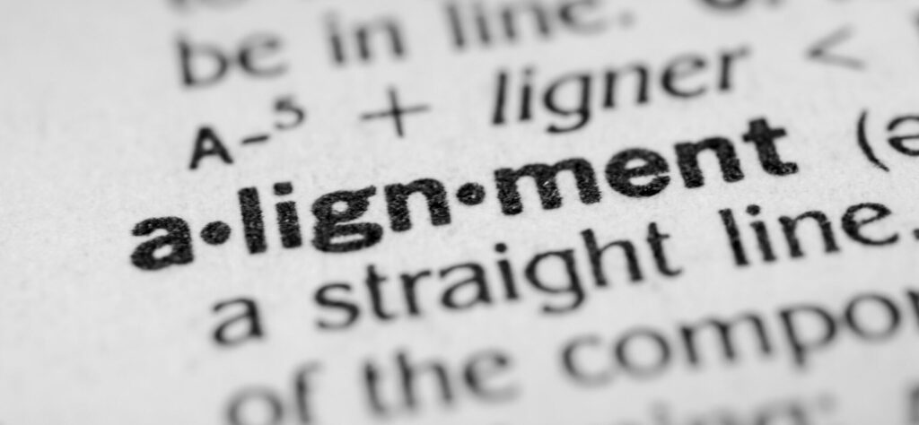 A close-up of the dictionary definition of the word “Alignment.”