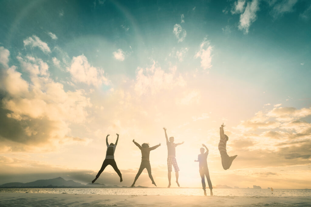 A group of people jumping for joy because they are breaking free from generational curses.