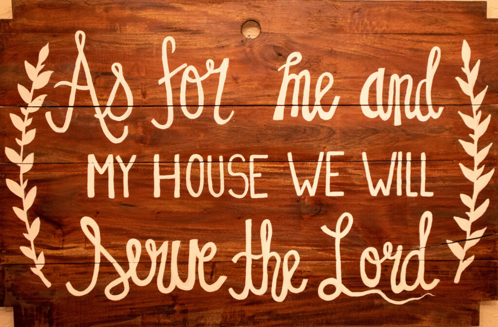 Wooden sign saying 'As for me and my house we will serve the Lord"