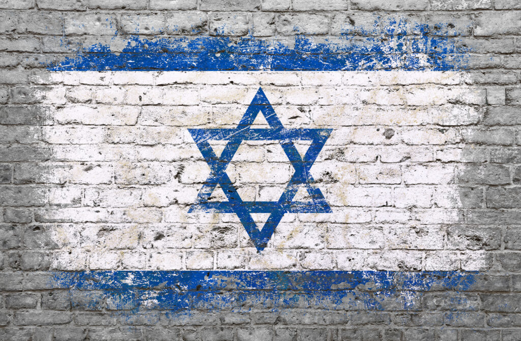 Grunge distressed flag of Israel painted on old weathered grey brick wall.