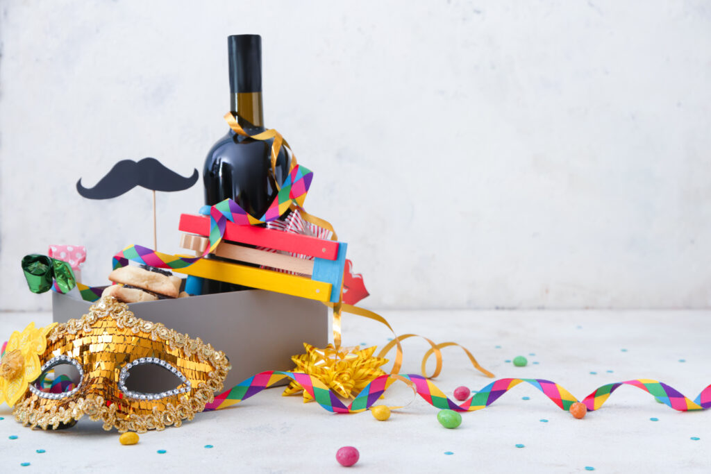  A box full of party supplies and a bottle of wine - all symbolizing the customs of Purim.