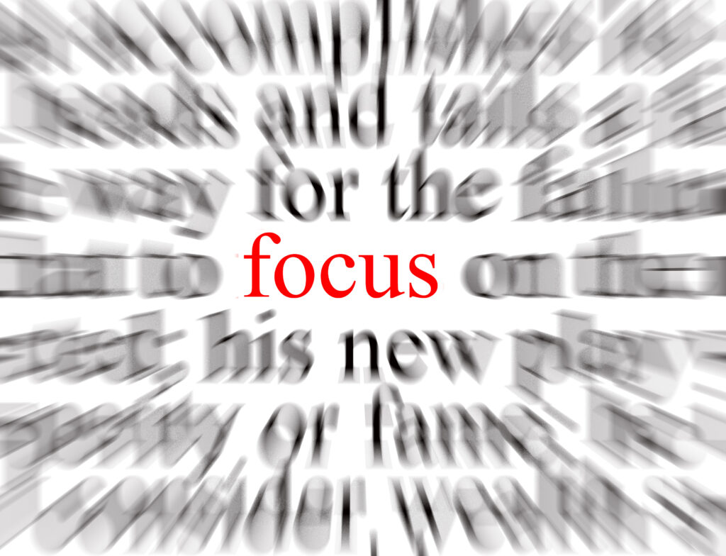 A series of blurred texted with only the word "focus" in red in focus.
