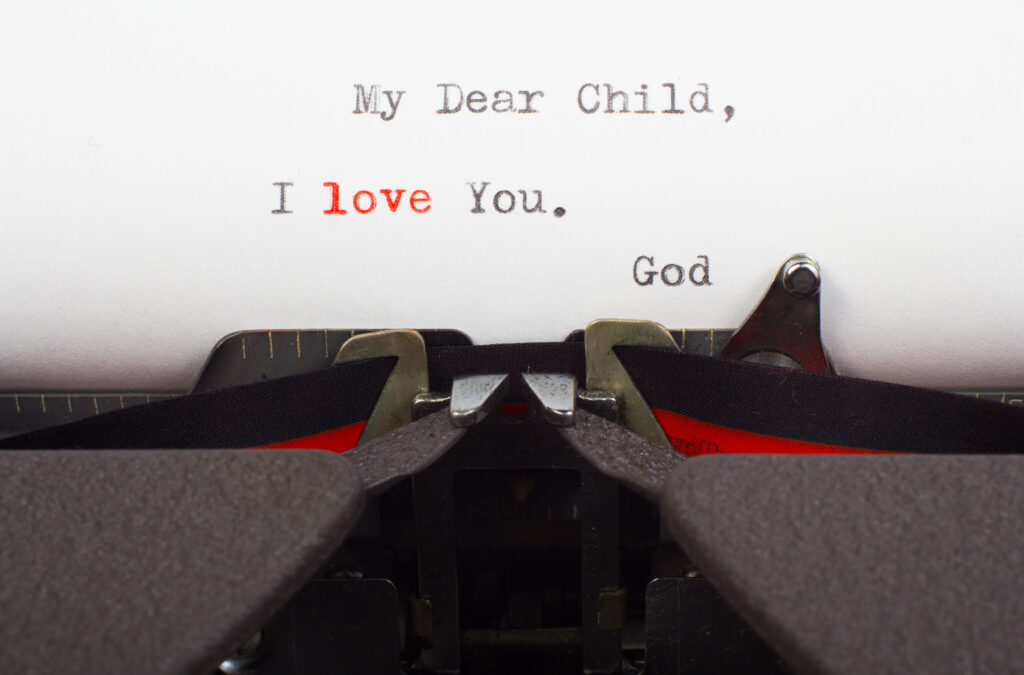 Letter on typewriter that reads my dear child, I love you, from God. 