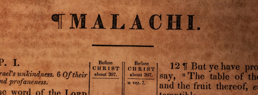 A close up of Book of Malachi header in Bible for biblical authority..