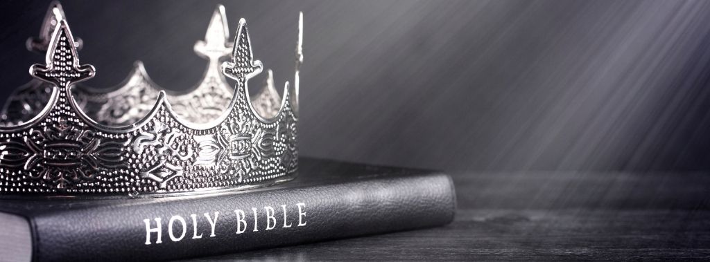 Black and White image of a crown on top of The Holy Bible.