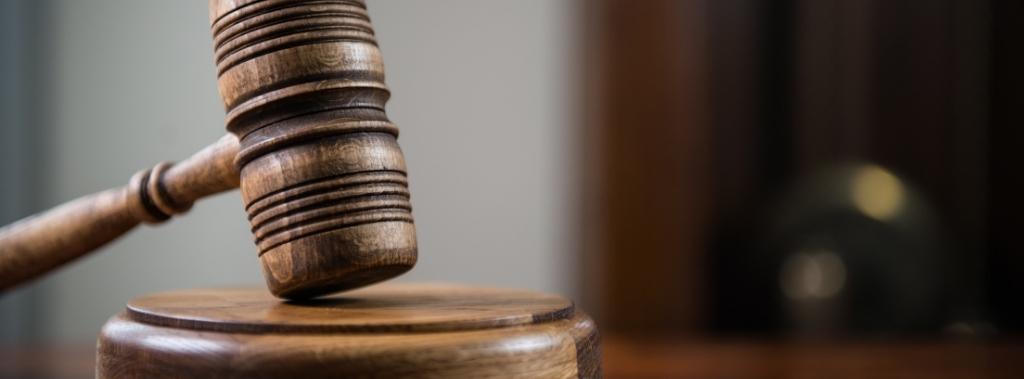 Close up of a wooden gavel in a court room.