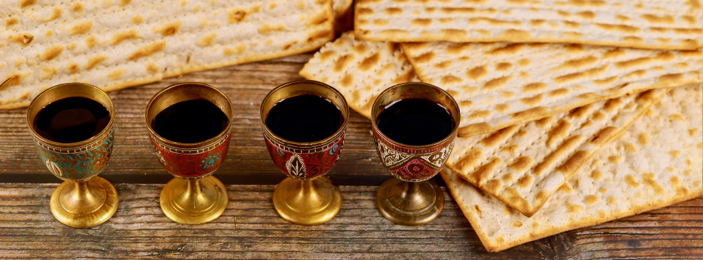 Four cups full of wine with matzah for Jewish holidays the represent the blood of passover lamb.