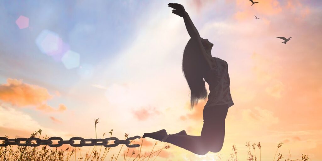 Woman jumping into the air, breaking free from her chains - Symbolism for “The gifts of healings.”