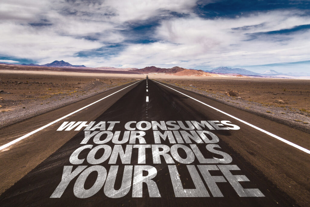 "What consumes your mind controls your life" written on a highway road