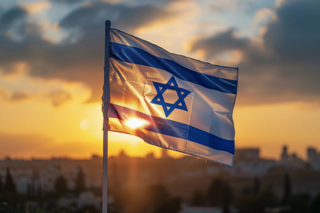 Solemn Israel flag waving at dusk with soft focus background.
